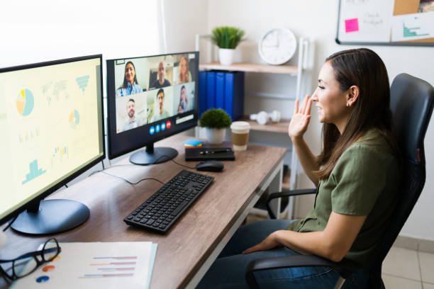 istock Female manager saying hi to her co-workersv 1332378883