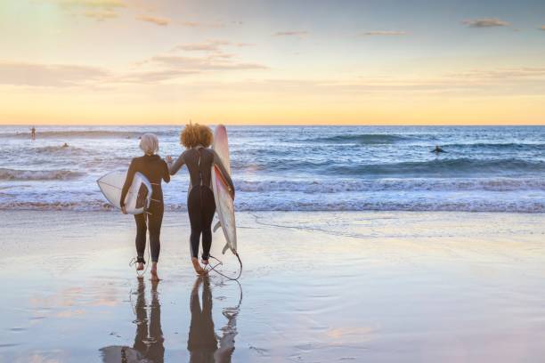 istock Friends heading out for a sunset surf session 1332378990