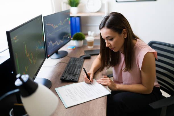 istock Young woman checking work papers at home 1332379649