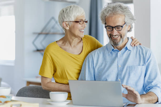istock A mature couple using a laptop at home and planning home finances 1332379720