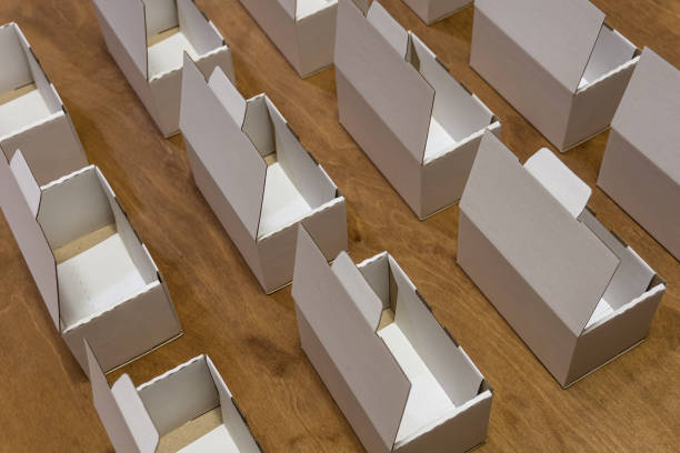 istock Small cardboard boxes are arranged in rows. Empty white boxes prepared for delivery. 1332384275