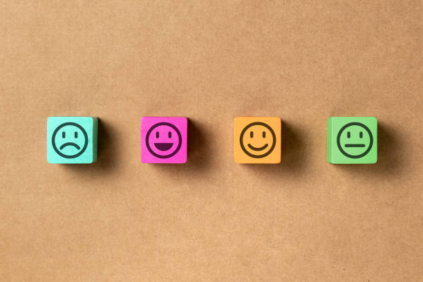 istock Emoticon faces in wooden blocks over brown background. Service evaluation and satisfaction survey concepts. Angry, neutral, good mood and happy. Copy space. 1332385018