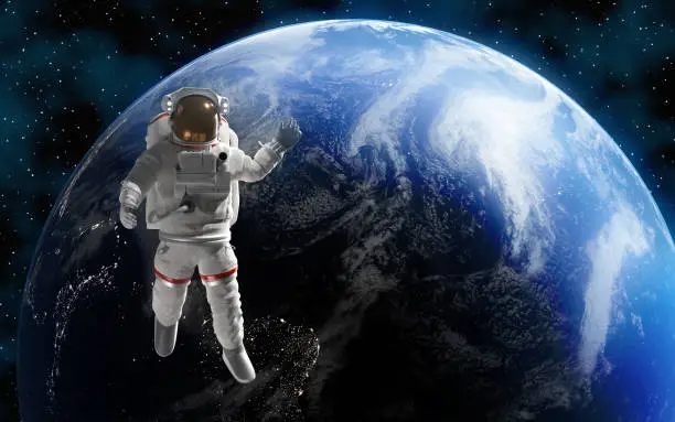 Astronaut or cosmonaut is in outer space for exploration with Planet Earth at background. Map image is courtesy of NASA: https://visibleearth.nasa.gov/images/57723/the-blue-marble. Easy to crop for all your social media and design need with copy space.