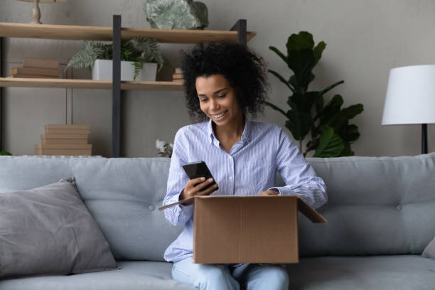 istock Happy biracial woman use cellphone check shipment status 1332387124