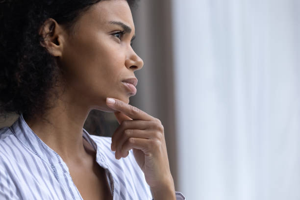 istock Unhappy biracial woman look in window thinking 1332387155