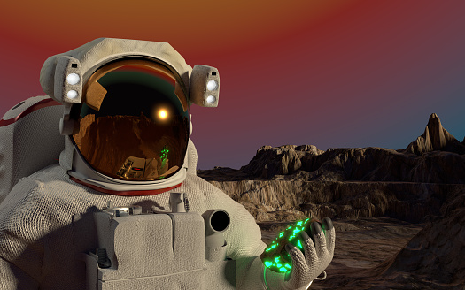 Astronaut or cosmonaut is on a planet’s surface in outer space for exploration with a green fantasy space rock on his hand. Easy to crop for all your social media and design need with copy space.