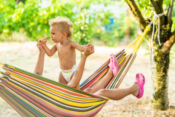 istock Baby boy playing with his mother at hammock 1332388260