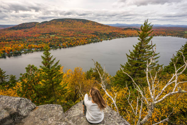 istock Woman looking at lake and forest during autumn. 1332390676
