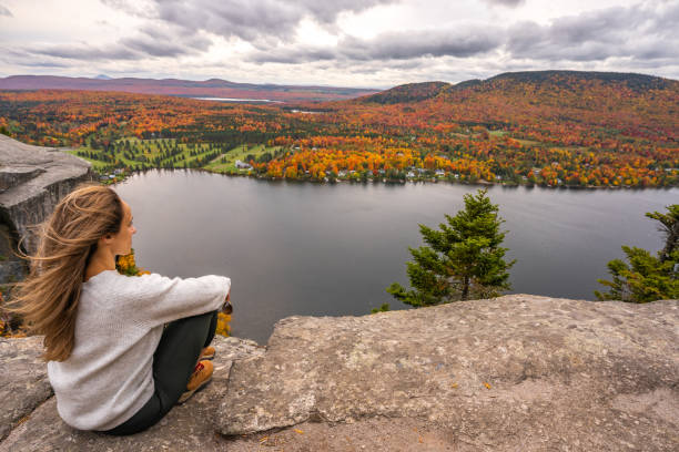 istock Woman looking at lake and forest during autumn. 1332390730