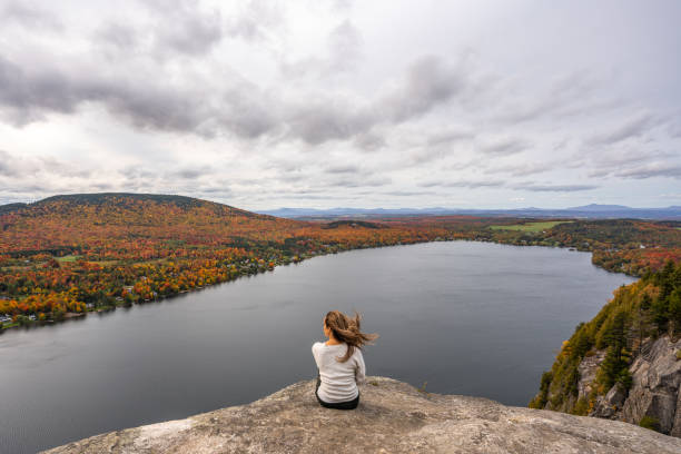 istock Woman looking at lake and forest during autumn. 1332390741