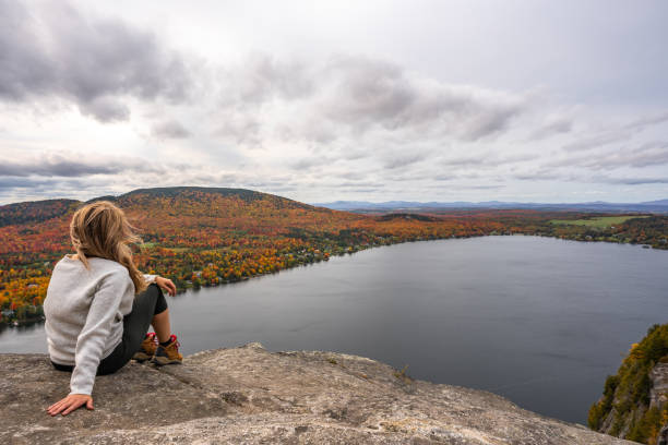 istock Woman looking at lake and forest during autumn. 1332390776
