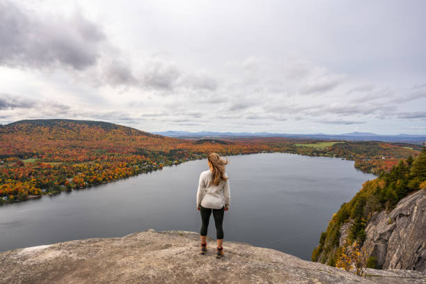 istock Woman looking at lake and forest during autumn. 1332390792