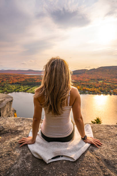 istock Woman looking at lake and forest during autumn. 1332391426