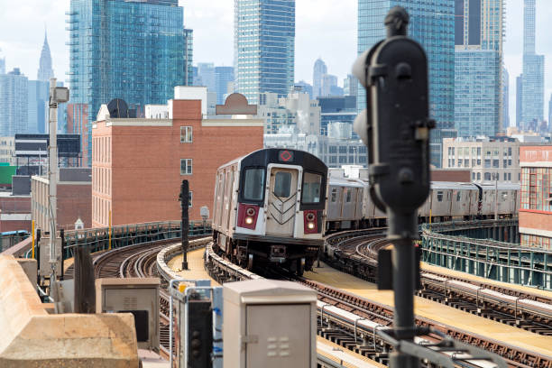 istock Subway Train Approaching  Elevated Subway Station in Queens, New York 1332391482