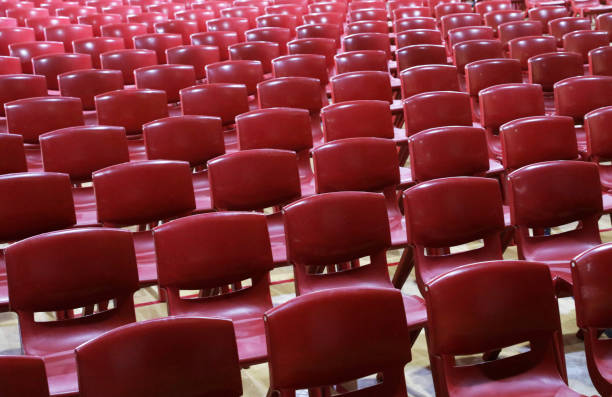 istock Masses of empty plastic chairs or seats in school assembly hall 1332397015