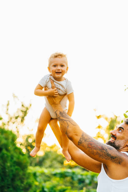 istock Father playing with his son outdoor 1332398697