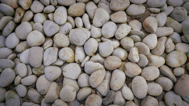 istock White stone background on the sunset beach 1332398703