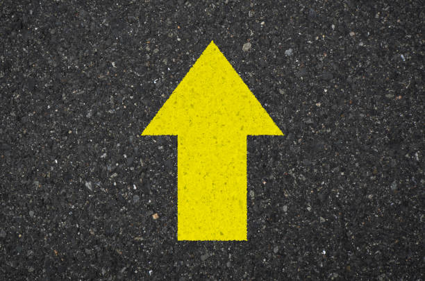 istock Asphalt with a yellow up arrow sign 1332399464