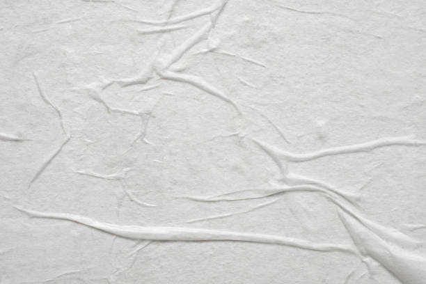 istock Blank white crumpled and creased paper poster texture 1332402471