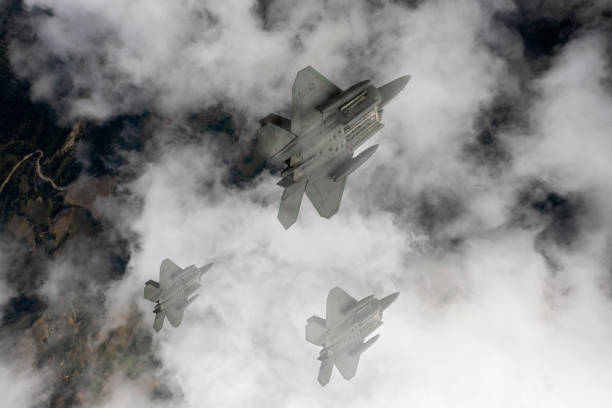 istock Jet fighters flying over the clouds. 1332402937