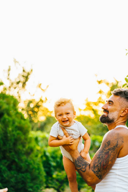 istock Father playing with his son outdoor 1332403792
