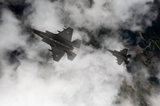 istock Jet fighters flying over the clouds. 1332403850
