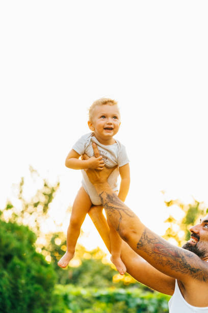 istock Father playing with his son outdoor 1332404547