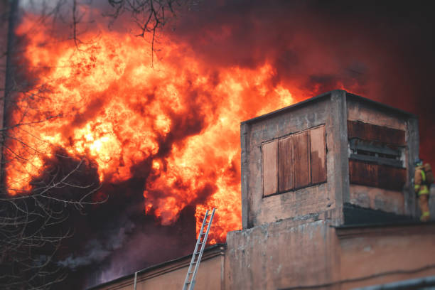 istock Massive large blaze fire in the city, brick factory building on fire, hell major fire explosion flame blast,  with firefighters team firemen on duty, arson, burning house damage destruction 1332404633