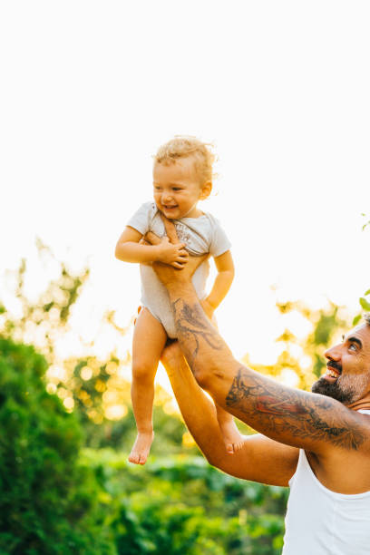 istock Father playing with his son outdoor 1332404639