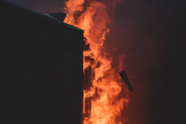istock Massive large blaze fire in the city, brick factory building on fire, hell major fire explosion flame blast,  with firefighters team firemen on duty, arson, burning house damage destruction 1332404686