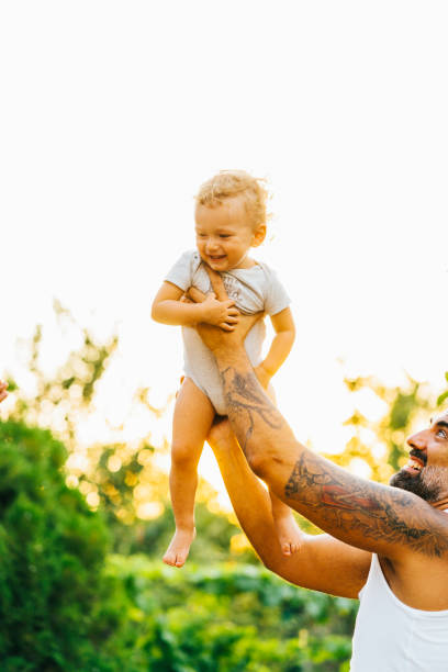 istock Father playing with his son outdoor 1332405380