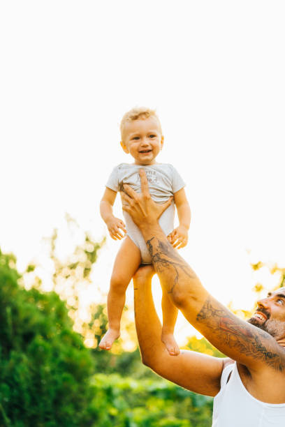 istock Father playing with his son outdoor 1332406226
