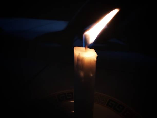 istock candle with wick burning in a dark room 1332407170