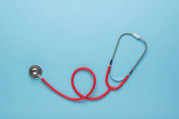 istock A neatly stacked stethoscope on a blue background. Space for the text. Flat lay. 1332417197