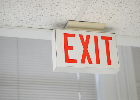 Closeup of an emergency exit sign in a public building.