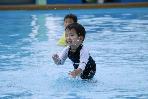 istock Children playing in swimming pool 1332423138
