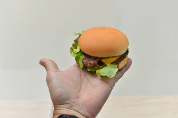 istock hand holding burger burger on hand 1332423953