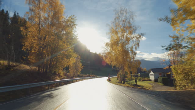 POV car driving by the fjords of Norway: outdoor in autumn