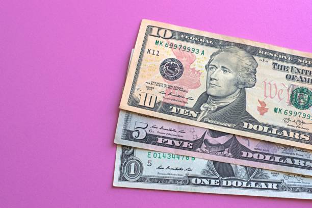 istock US dollars laid out on a pink background 1332426097