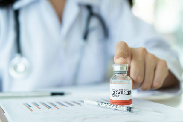 Doctor working in office. Asian female doctor reporting a diagnostic result of Coronavirus or COVID-19 vaccine usage in patient, 2019-nCoV COVID19 cases statistic. Woman analyst - researcher making a video conference. covid secure photos stock pictures, royalty-free photos & images