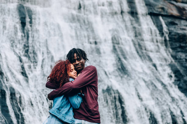 istock Romantic couple at waterfall 1332430174