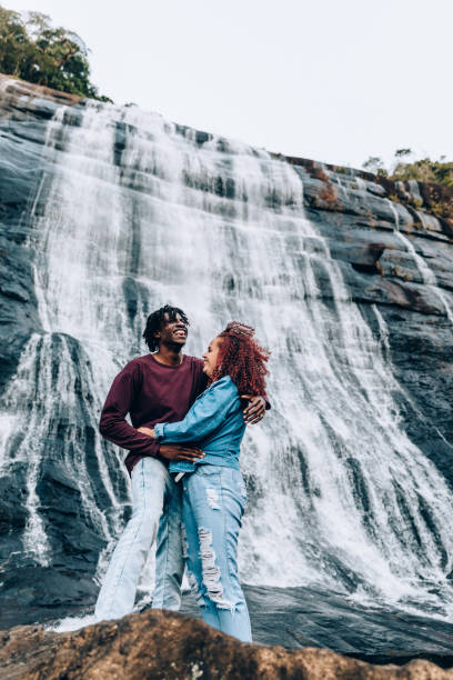istock Happy couple at waterfall 1332430265