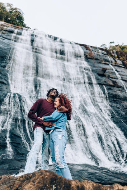 istock Happy couple at waterfall 1332430273