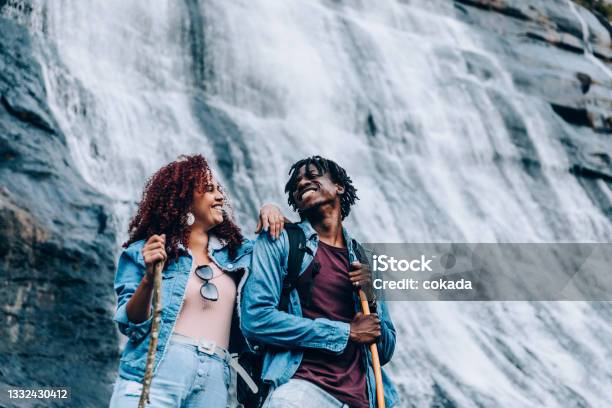 Couple At Waterfall Stock Photo - Download Image Now - Hiking, Waterfall, Couple - Relationship