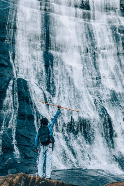 istock Cheerfull happy man at waterfall 1332430417