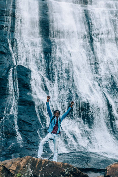 istock Cheerfull happy man at waterfall 1332430956
