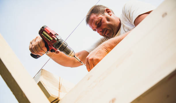 istock Construction worker on the wooden frame of a roof 1332431168