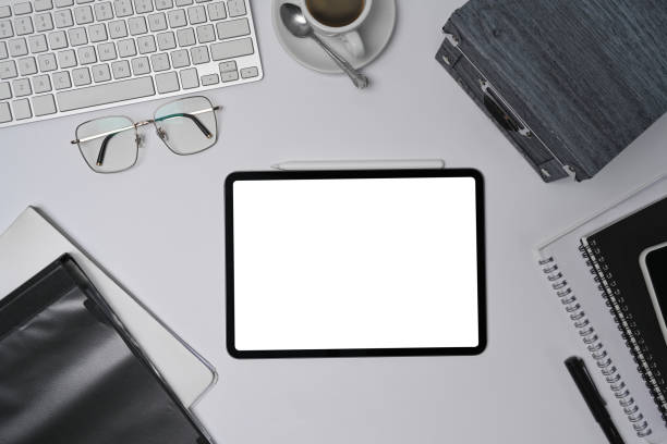 istock Mock up digital tablet and office supplies on modern workspace. 1332431271