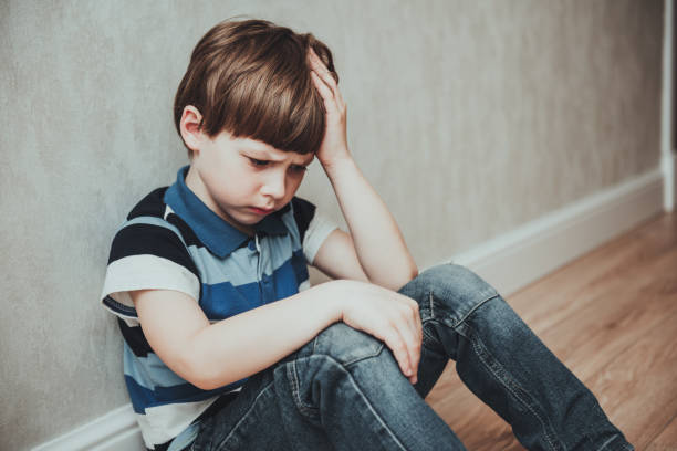 istock Regret sad little boy sitting alone loneliness,stressed depressed child crying having depression, anxiety, trouble of mental health, lonely kid boy with hand on head 1332432143