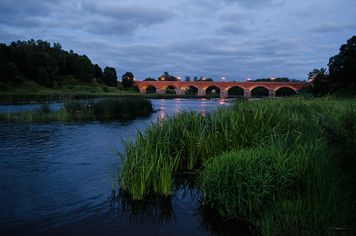 Long brick bridge in summer night, Kuldiga, Latvia